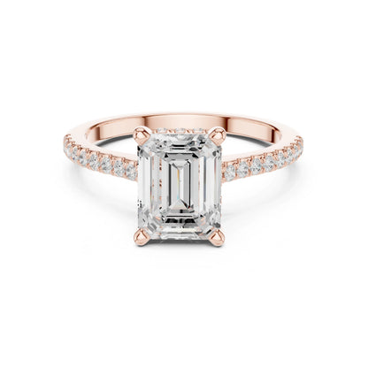 Rose gold ring with a large moissanite diamond and smaller diamonds on the band against a white background