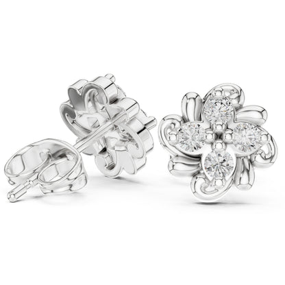 Silver flower-shaped earrings with clear moissanite gemstones on a white background