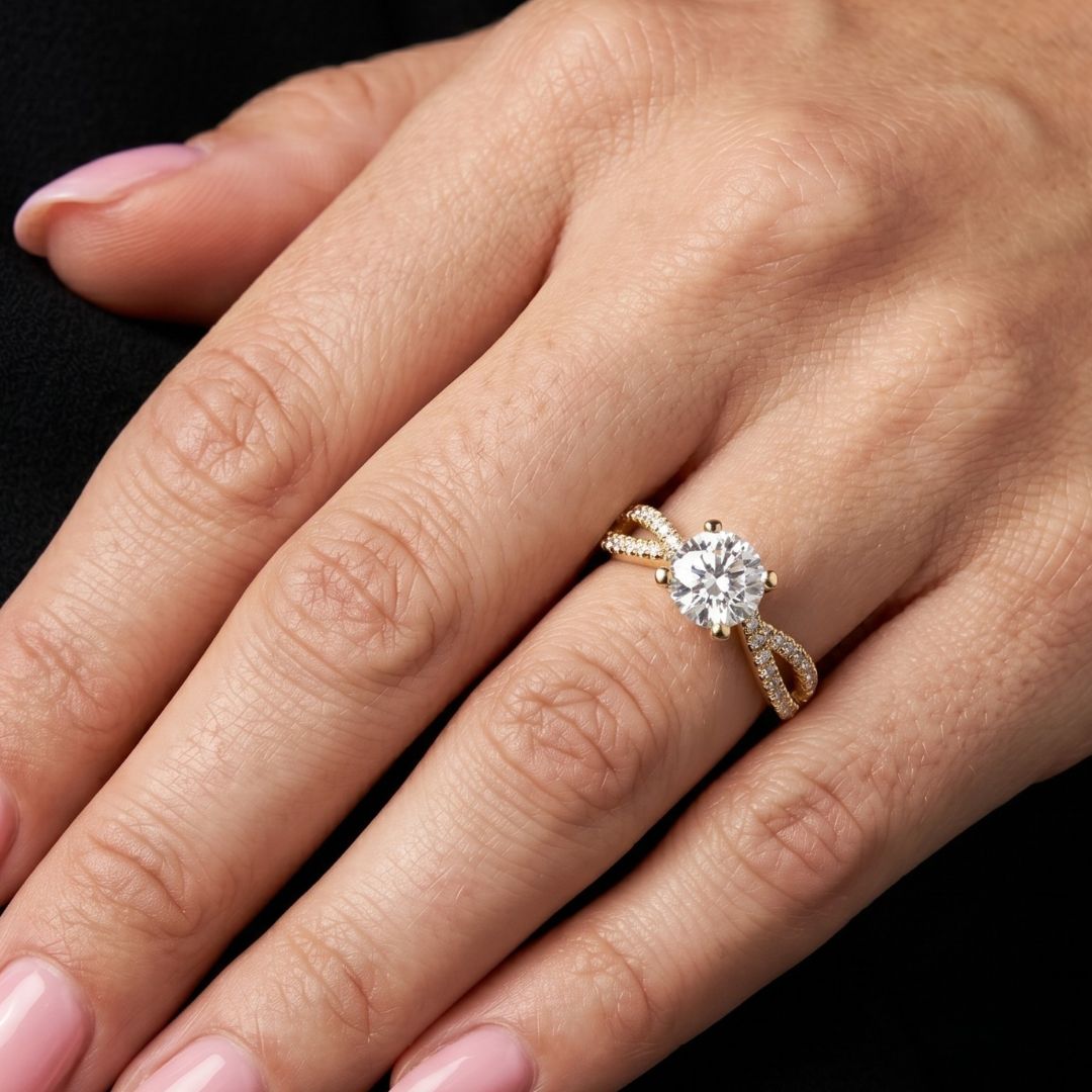 Rose gold ring with a moissanite diamond on a hand against a black background