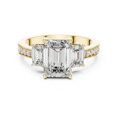Gold ring with emerald-cut moissanite diamonds on a white background