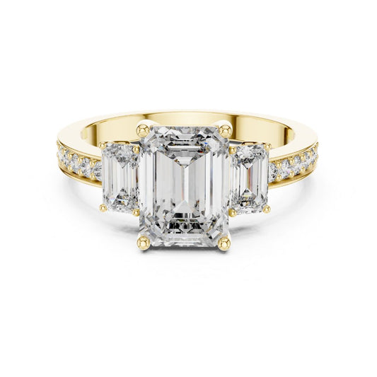 Gold ring with emerald-cut moissanite diamonds on a white background