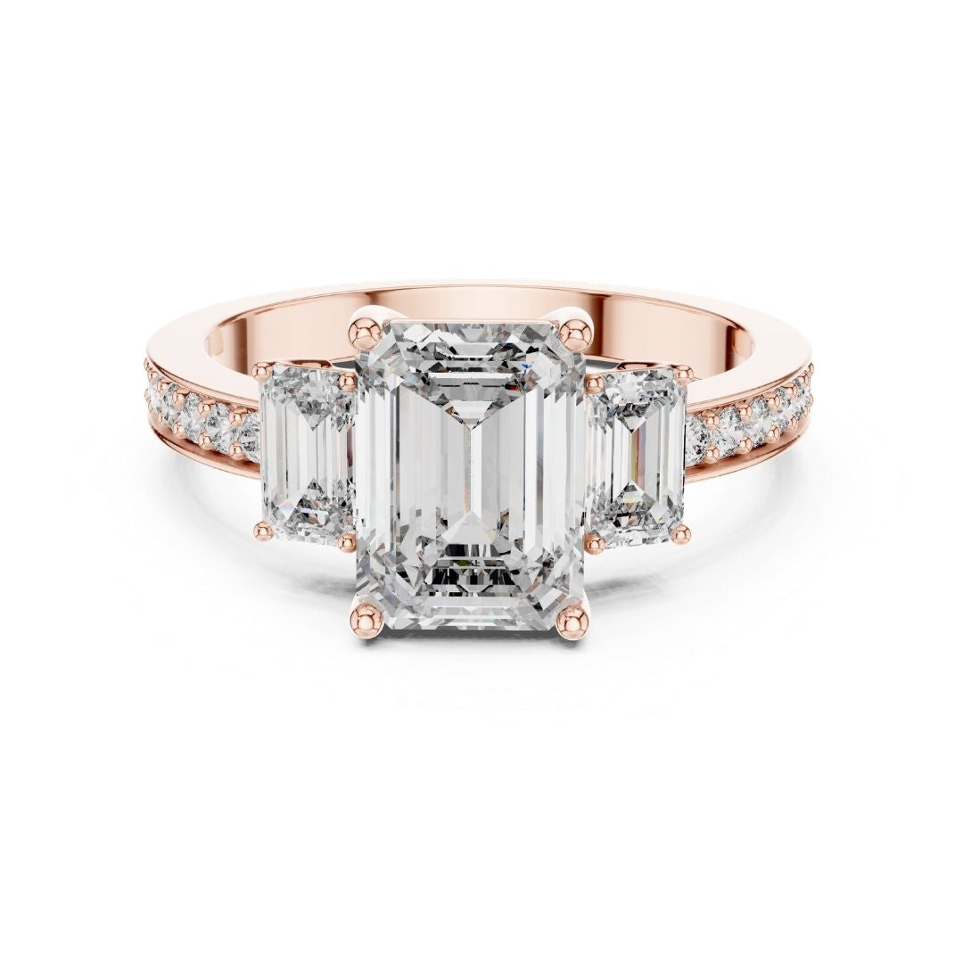 Rose gold ring with emerald-cut moissanite diamonds on a white background
