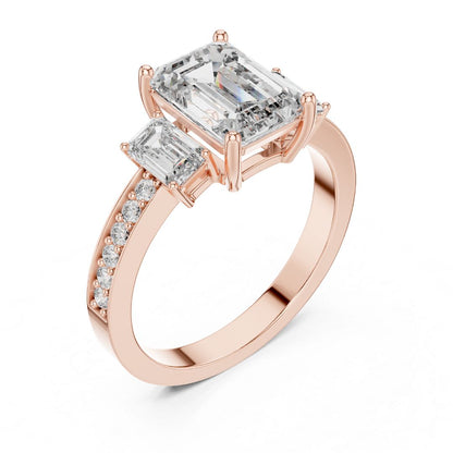Rose gold ring with emerald-cut moissanite diamonds on a white background