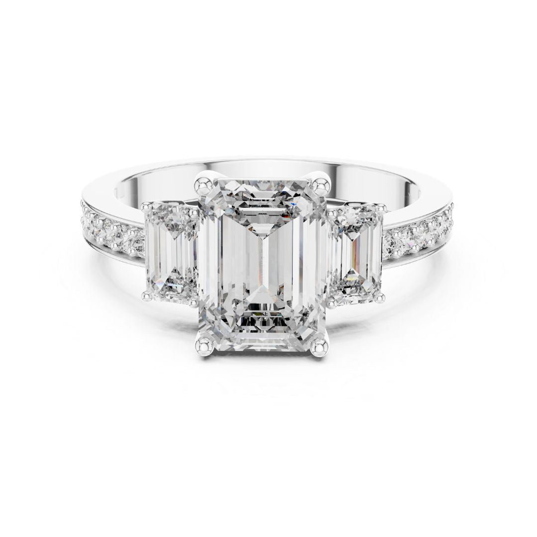 Diamond ring with emerald-cut center moissanite stone and smaller diamonds on a white background