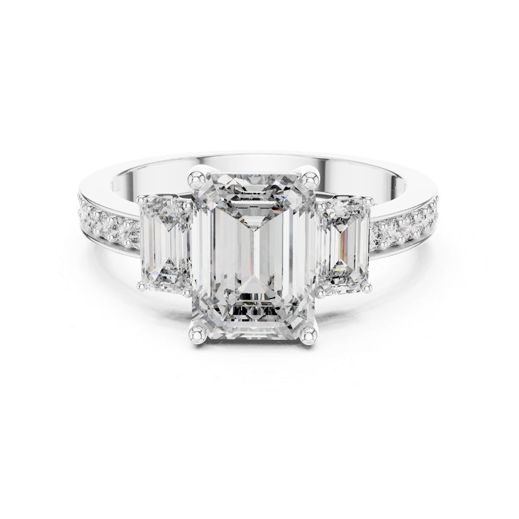 Diamond ring with emerald-cut center moissanite stone and smaller diamonds on a white background