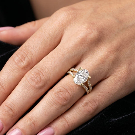 Close-up of a hand wearing a rose gold moissanite  diamond ring.