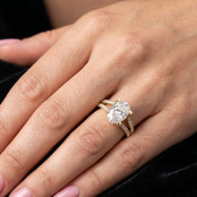 Load image into Gallery viewer, Close-up of a hand wearing a rose gold moissanite  diamond ring.