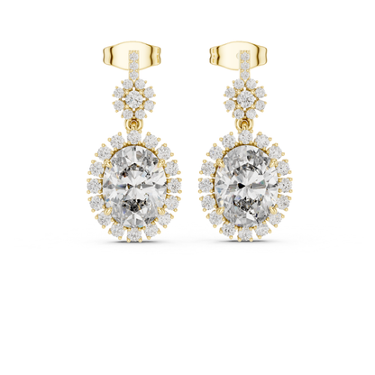 Gold earrings with clear moissanite  gemstones on a white background