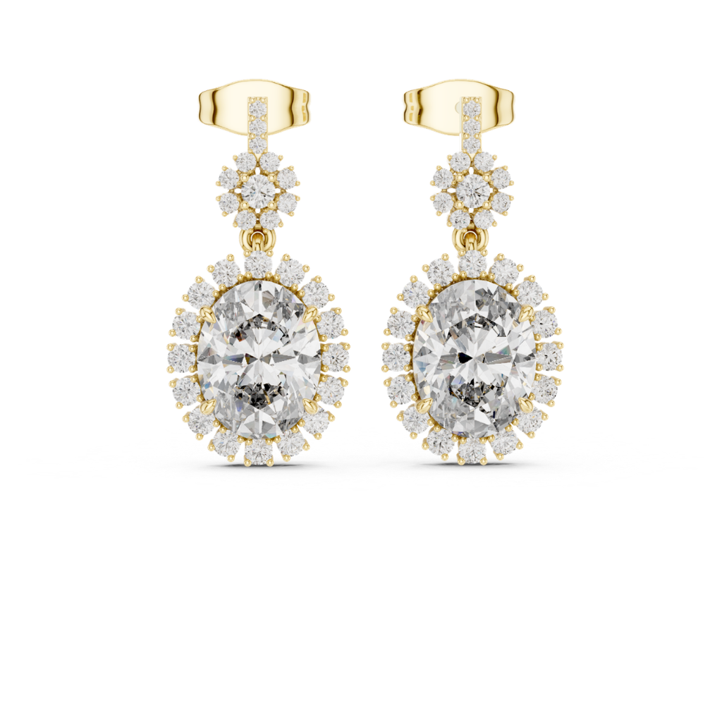 Gold earrings with clear moissanite  gemstones on a white background