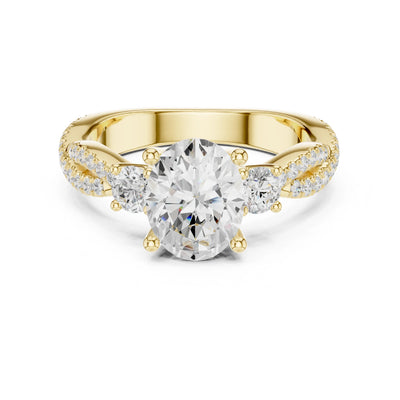 Gold ring with a large moissanite diamond and smaller diamonds on the band against a white background
