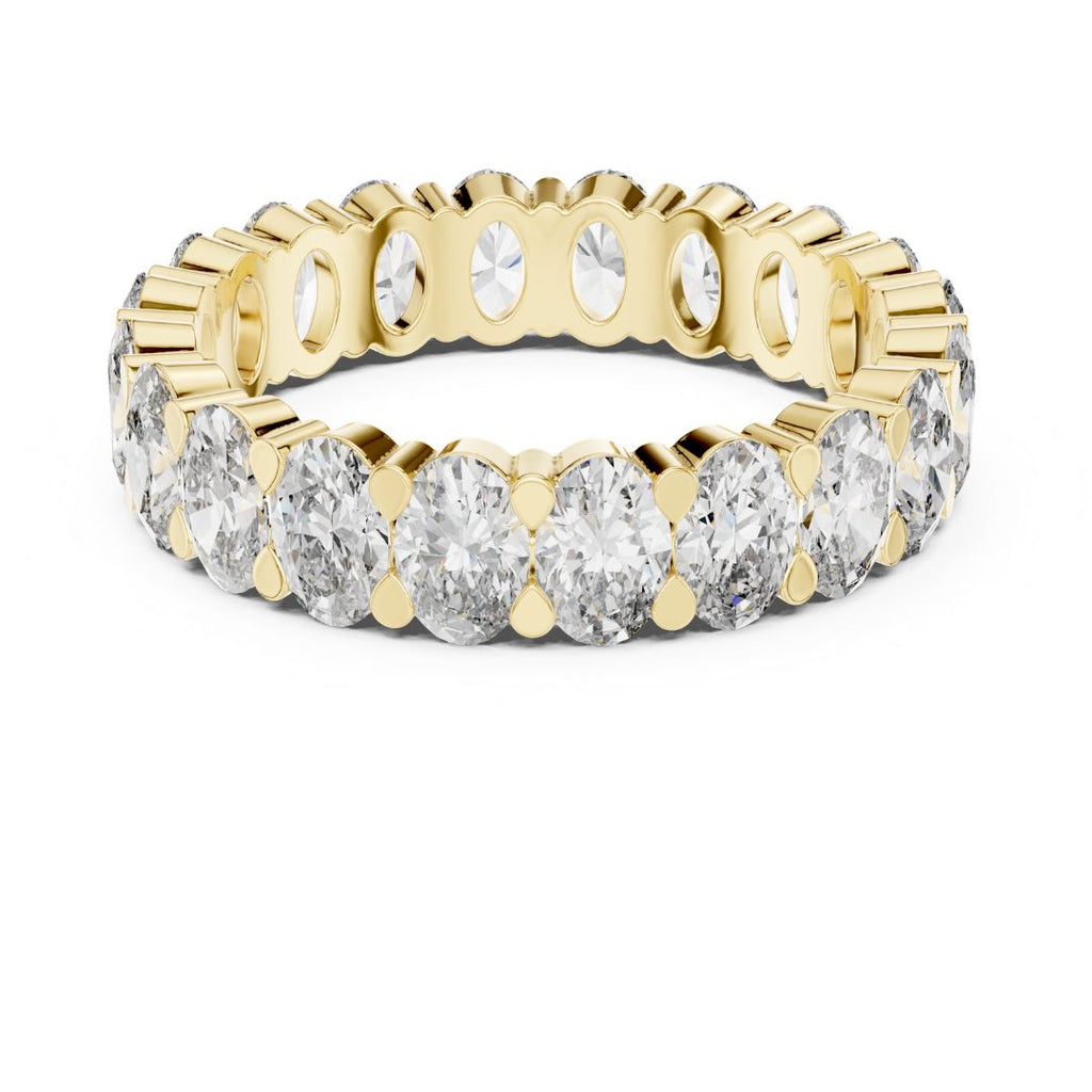 Gold and moissanite diamond ring on a white background