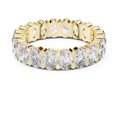 Gold and moissanite diamond ring on a white background