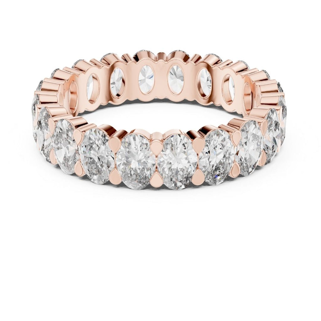 Rose gold ring with clear moissanite gemstones on a white background