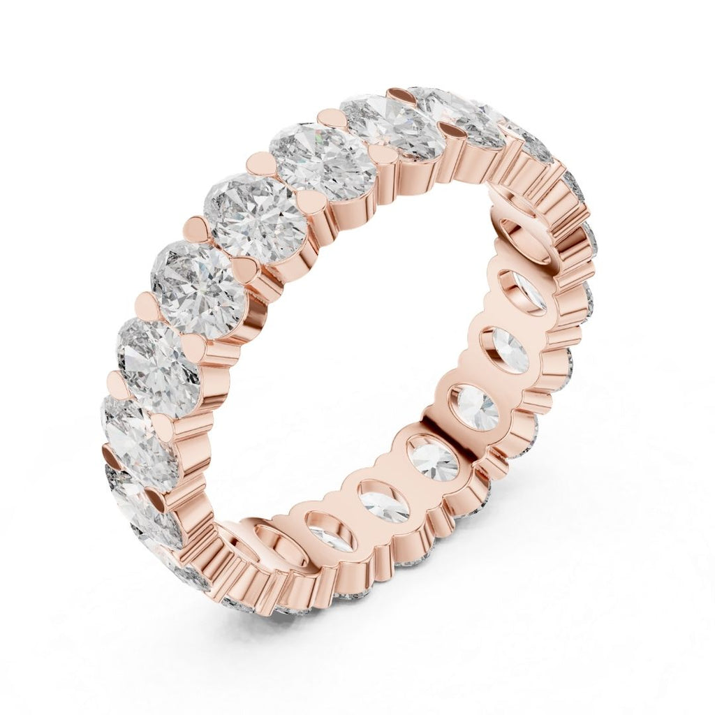 Rose gold ring with moissanite diamonds on a white background