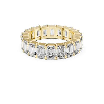 Gold ring with emerald-cut Moissanite diamonds on a white background