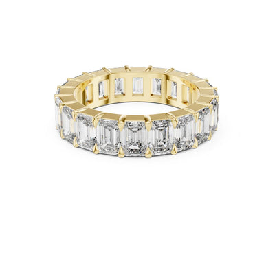 Gold ring with emerald-cut Moissanite diamonds on a white background