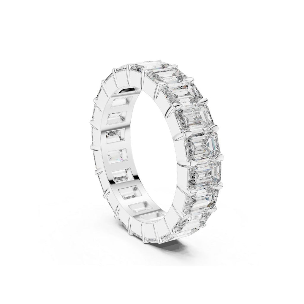 Diamond ring with Emerald Moissanite stones on a white background