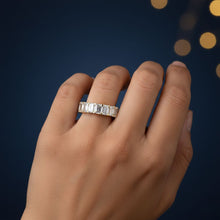 Load image into Gallery viewer, Hand wearing a Moissanite diamond ring with a dark blue background