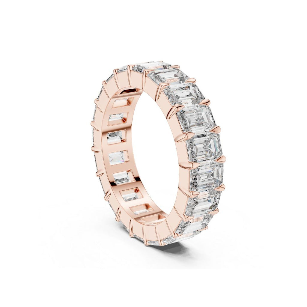 Rose gold ring with clear Emerald  Moissanite gemstones on a white background