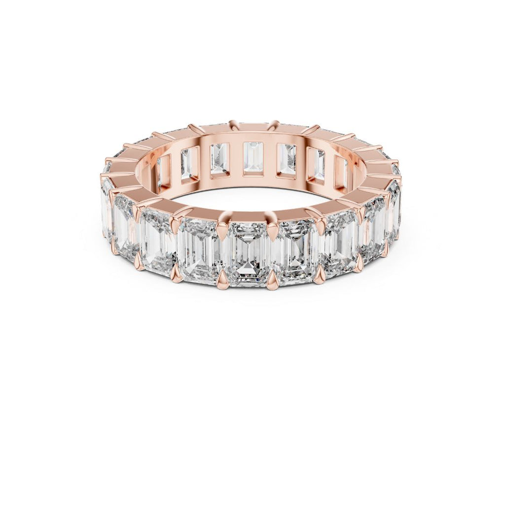 Rose gold ring with emerald-cut Moissanite diamonds on a white background