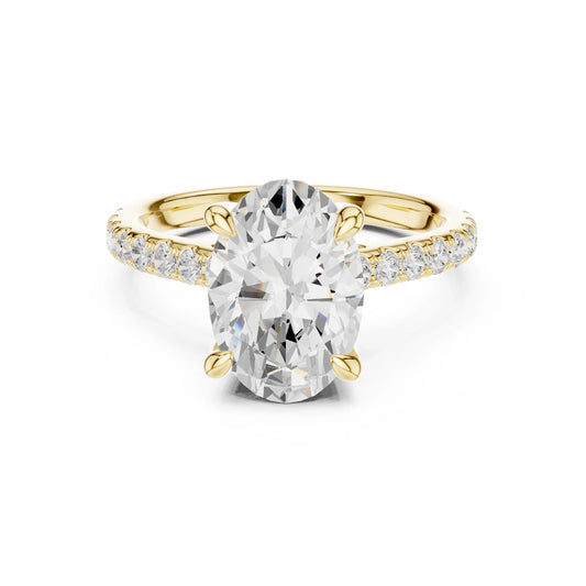 Gold ring with a large moissanite diamond and smaller diamonds on the band against a white background