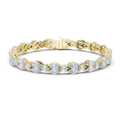 A yellow gold tennis bracelet featuring a continuous row of round-cut clear moissanite gemstones in a prong setting, displayed on a clean white background.