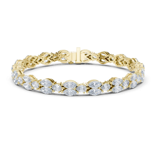 A yellow gold tennis bracelet featuring a continuous row of round-cut clear moissanite gemstones in a prong setting, displayed on a clean white background.
