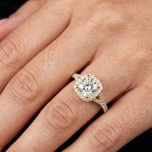 Load image into Gallery viewer, Gold ring with a moissanite diamond on a person's finger against a dark background