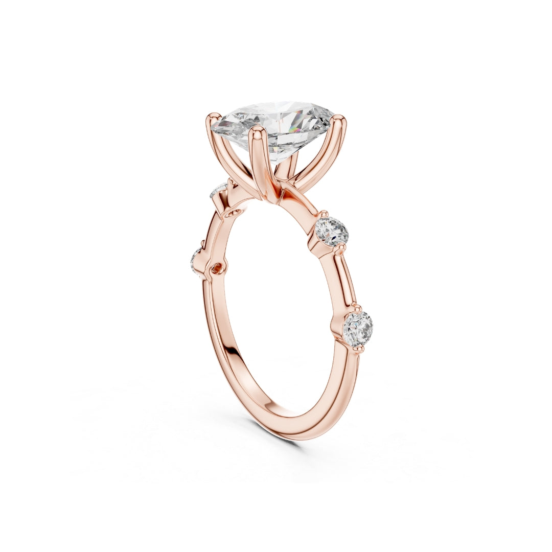 Rose gold ring with a 2CT MOISSANITE central diamond and smaller side diamonds on a white background