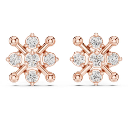 Rose gold earrings with clear Moissanite gemstones on a white background
