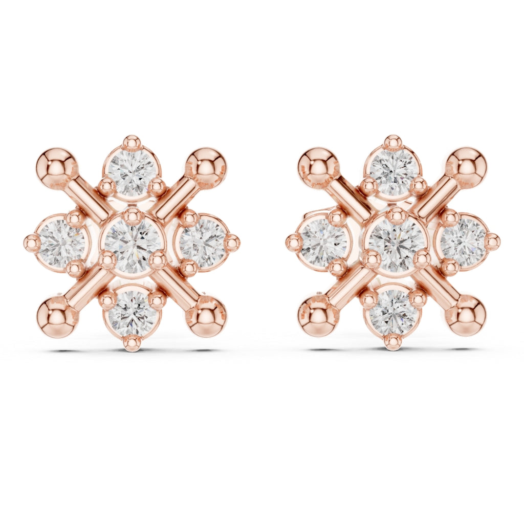 Rose gold earrings with clear Moissanite gemstones on a white background