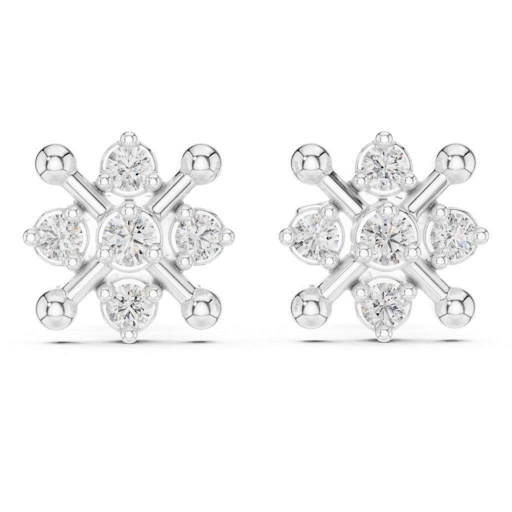 Snowflake-shaped silver earrings with clear moissanite gemstones on a white background