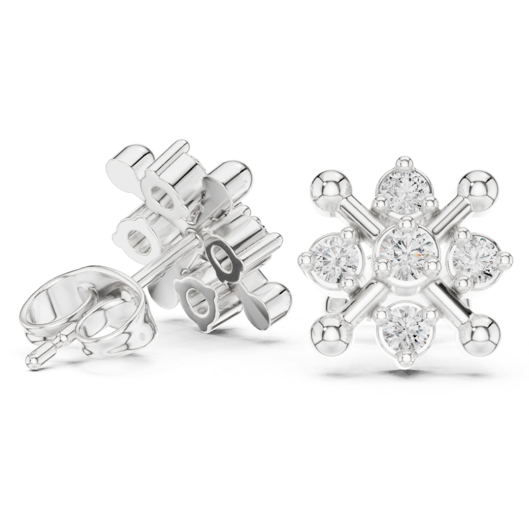Silver snowflake-shaped earrings with clear moissanite gemstones on a white background