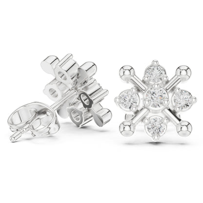 Silver snowflake-shaped earrings with clear moissanite gemstones on a white background