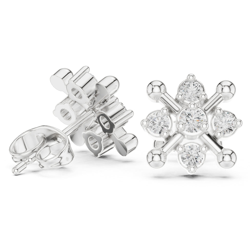 Silver snowflake-shaped earrings with clear moissanite gemstones on a white background