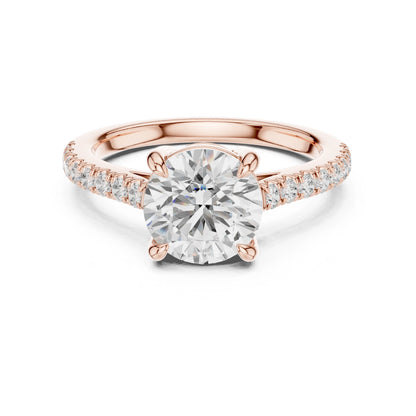 Rose gold ring with a large moissanite diamond and smaller diamonds on the band against a white background