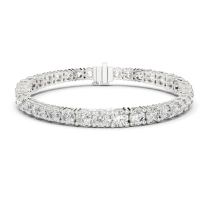 A diamond tennis bracelet in a silver-toned metal setting, featuring a continuous row of round and baguette-cut  moissanite diamonds with a rectangular clasp, shown on a plain white background.