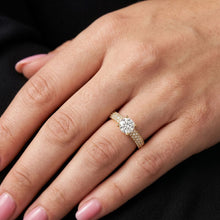Load image into Gallery viewer, Rose gold ring with a moissanite diamond on a hand against a black background