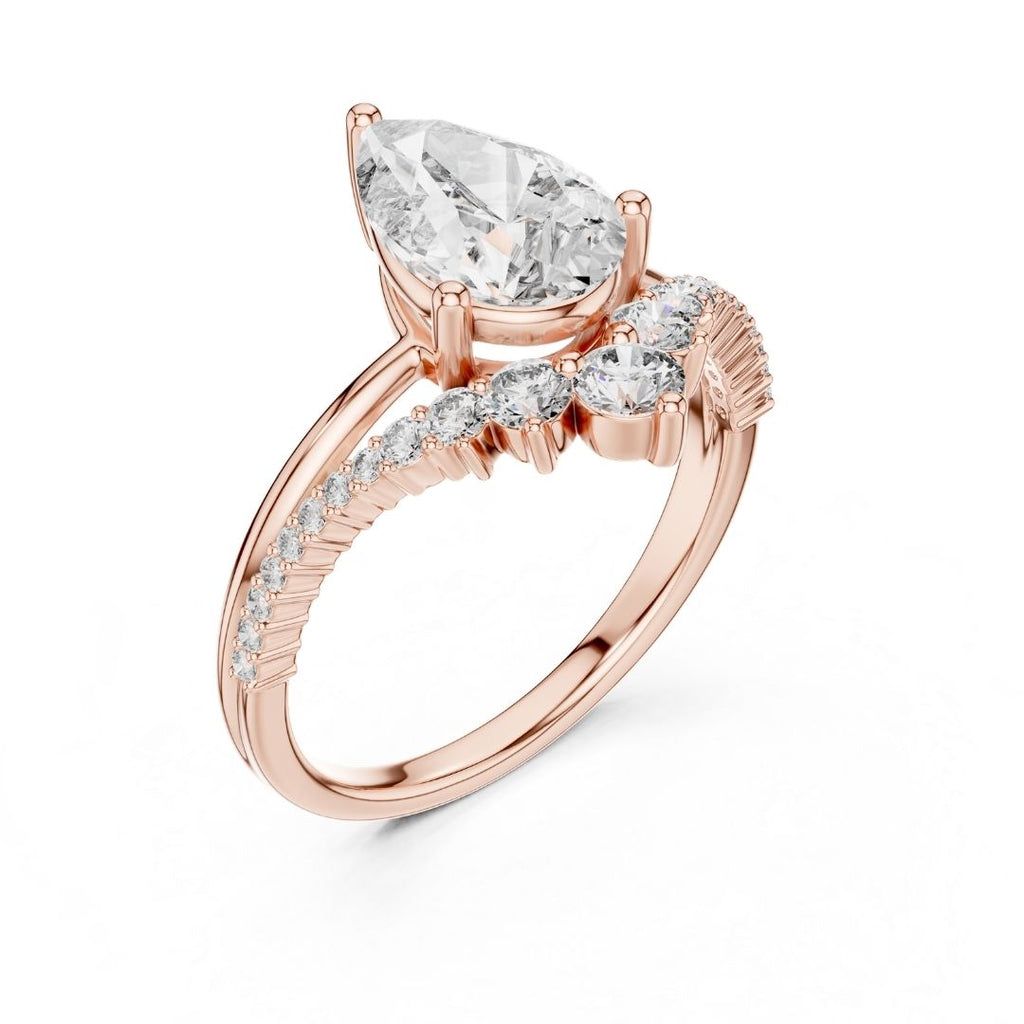 Rose gold ring with a pear-shaped moissanite diamond on a white background