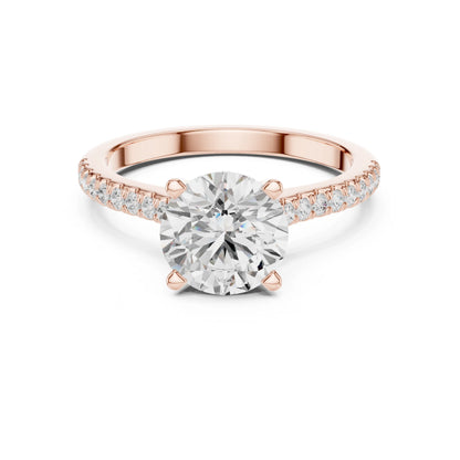 Rose gold ring with a large moissanite  diamond and smaller diamonds on the band against a white background