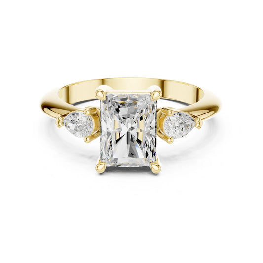 Gold ring with a central moissanite diamond and two smaller diamonds on a white background