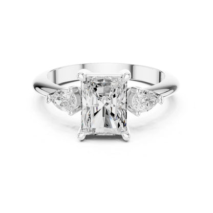 moissanite Diamond ring with a central princess-cut diamond flanked by two pear-shaped diamonds on a white background