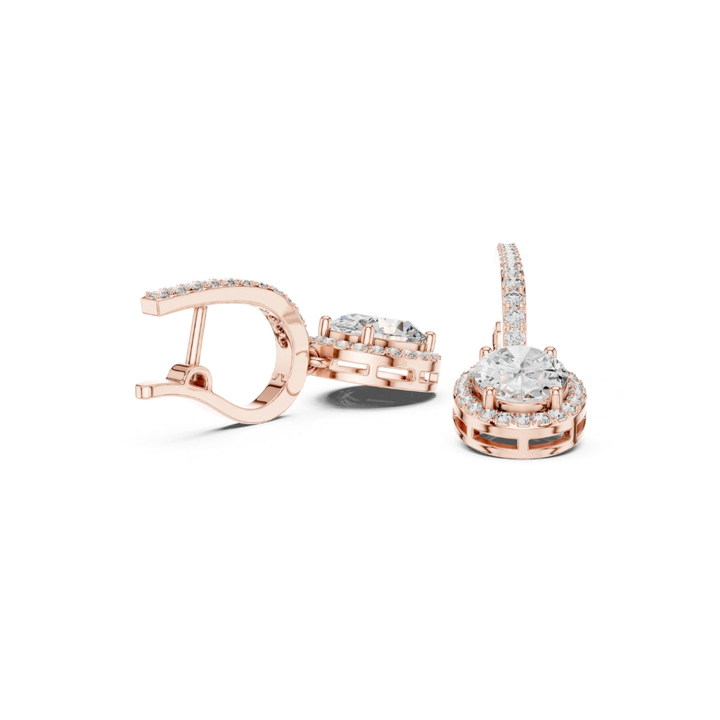 Rose gold earrings with moissanite diamond accents on a white background