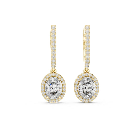Gold earrings with clear gemstones on a white background