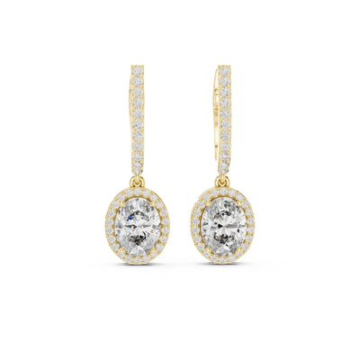 Gold earrings with clear gemstones on a white background