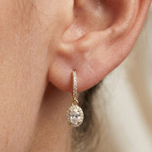 Load image into Gallery viewer, Close-up of an ear wearing a gold hoop earring with a moissanite clear gemstone.