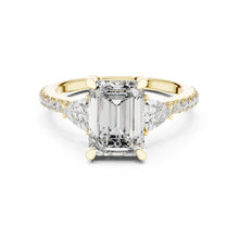 Load image into Gallery viewer, Gold ring with a large moissanite  diamond and smaller diamonds on the band against a white background