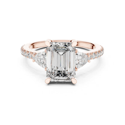 Rose gold ring with a large moissanite diamond and smaller diamonds on the band against a white background
