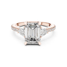 Load image into Gallery viewer, Rose gold ring with a large moissanite  diamond and smaller diamonds on the band against a white background