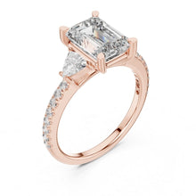 Load image into Gallery viewer, Rose gold ring with a large moissanite diamond and smaller diamonds on a white background
